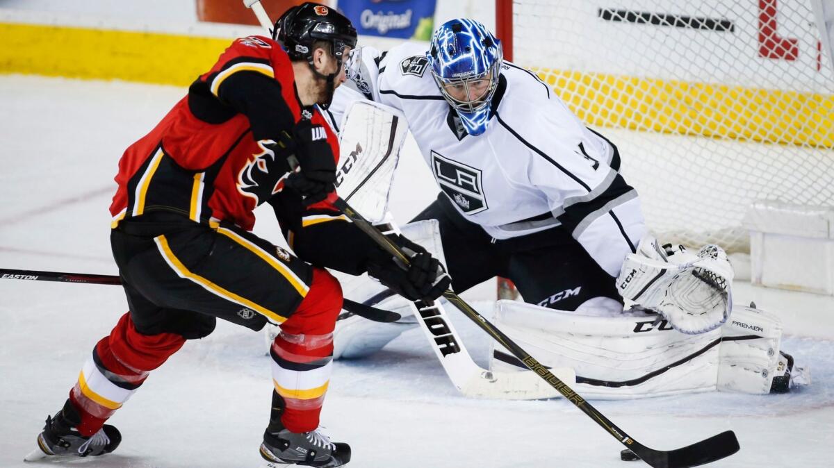 Kings goalie Ben Bishop tries to stop Calgary's TJ Brodie from scoring during overtime on Feb. 28.