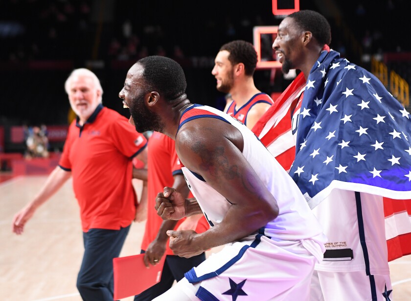 U.S. basketball forward Draymond Green cheers alongside other players at the Tokyo Olympics.