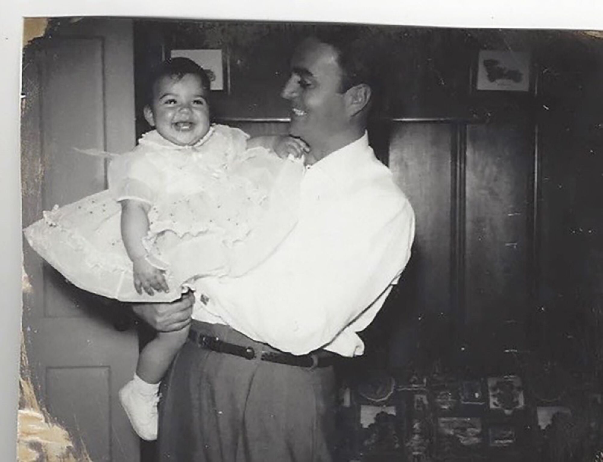 Hank Caruso holds his daughter Christina Caruso in the early 1960s inside their home. 