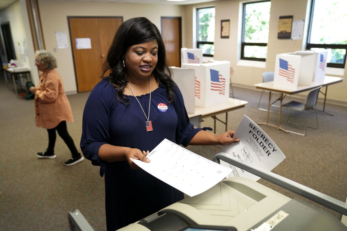 Iowa Democratic gubernatorial candidate Deidre DeJear casts her ballot for the Iowa primary at Calvary Chapel, Tuesday, June 7, 2022, in Des Moines, Iowa. (AP Photo/Charlie Neibergall)