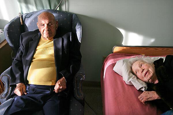 Harry Cooper, 98, and his wife Barbara, 93, relax before dinner at Hollenbeck Palms nursing home. See full story