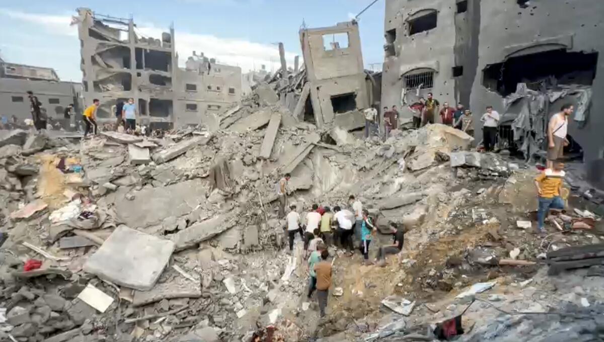 People search through massive piles of rubble in Jabaliya refugee camp in the Gaza Strip.