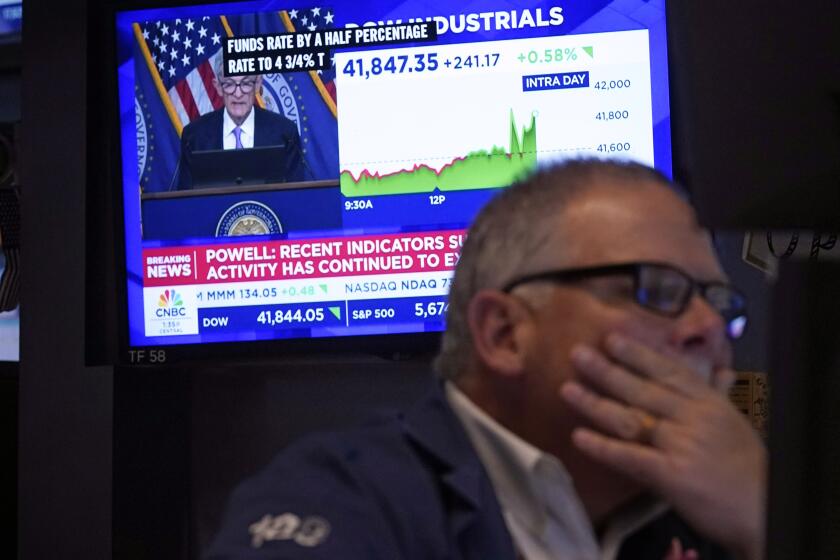 Trader Michale Conlon, right, works on the floor of the New York Stock Exchange as Federal Reserve Chair Jerome Powell's news conference appears on a television screen behind him, Wednesday, Sept. 18, 2024. (AP Photo/Richard Drew)