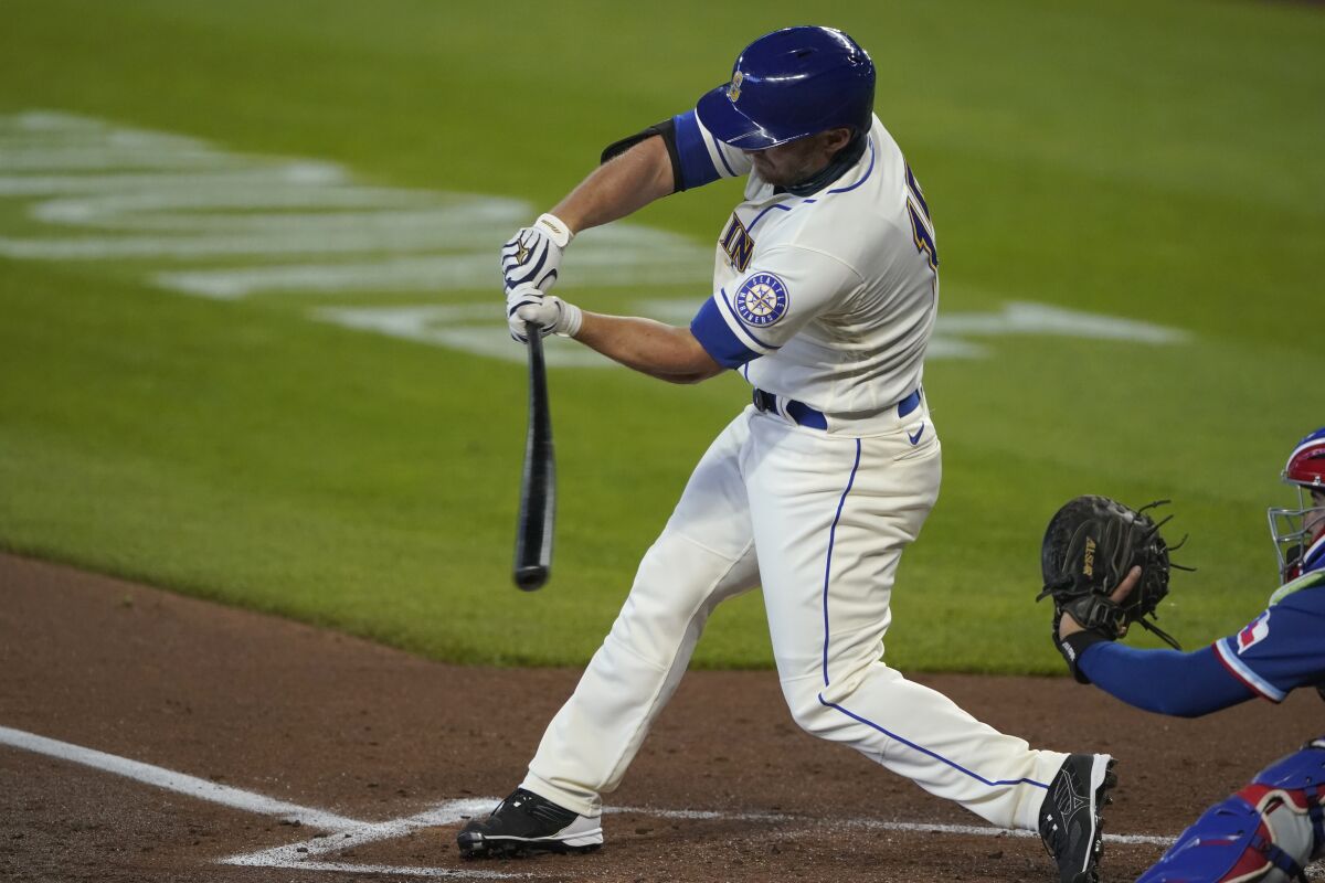 Seattle Mariners' Kyle Seager begins his swing as he hits a two-run home run against the Texas Rangers during the first inning of a baseball game, Sunday, Sept. 6, 2020, in Seattle. (AP Photo/Ted S. Warren)
