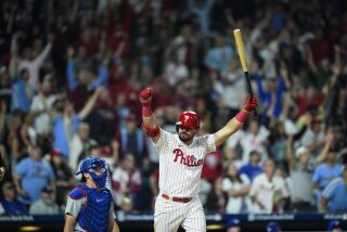 Philadelphia Phillies' Kyle Schwarber, right, reacts after hitting a home run off Los Angeles Dodgers' Caleb Ferguson during the ninth inning of a baseball game, Friday, June 9, 2023, in Philadelphia. (AP Photo/Matt Rourke)