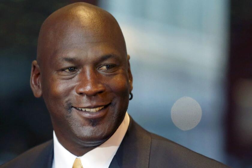 FILE - In this Aug. 21, 2015, file photo, former NBA star and current owner of the Charlotte Hornets, Michael Jordan smiles at reporters in Chicago. A quarter century after being famously excluded from the cult favorite video game NBA Jam, Jordan is investing in esports. Jordan on Thursday, Oct. 25, 2018, was announced as an investor with aXiomatic, a major esports ownership group whose properties include powerhouse franchise Team Liquid. (AP Photo/Charles Rex Arbogast, File)