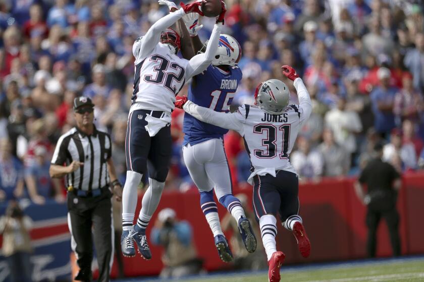 FILE - In this Sept. 29, 2019, file photo, New England Patriots safety Devin McCourty (32) intercepts a pass intended for Buffalo Bills wide receiver John Brown (15) in the first half of an NFL football game, in Orchard Park, N.Y. Despite showing some vulnerability in their loss to the Ravens, the Patriots' defense remains one of the NFL's best heading into the second half of 2019. (AP Photo/Ron Schwane, File)