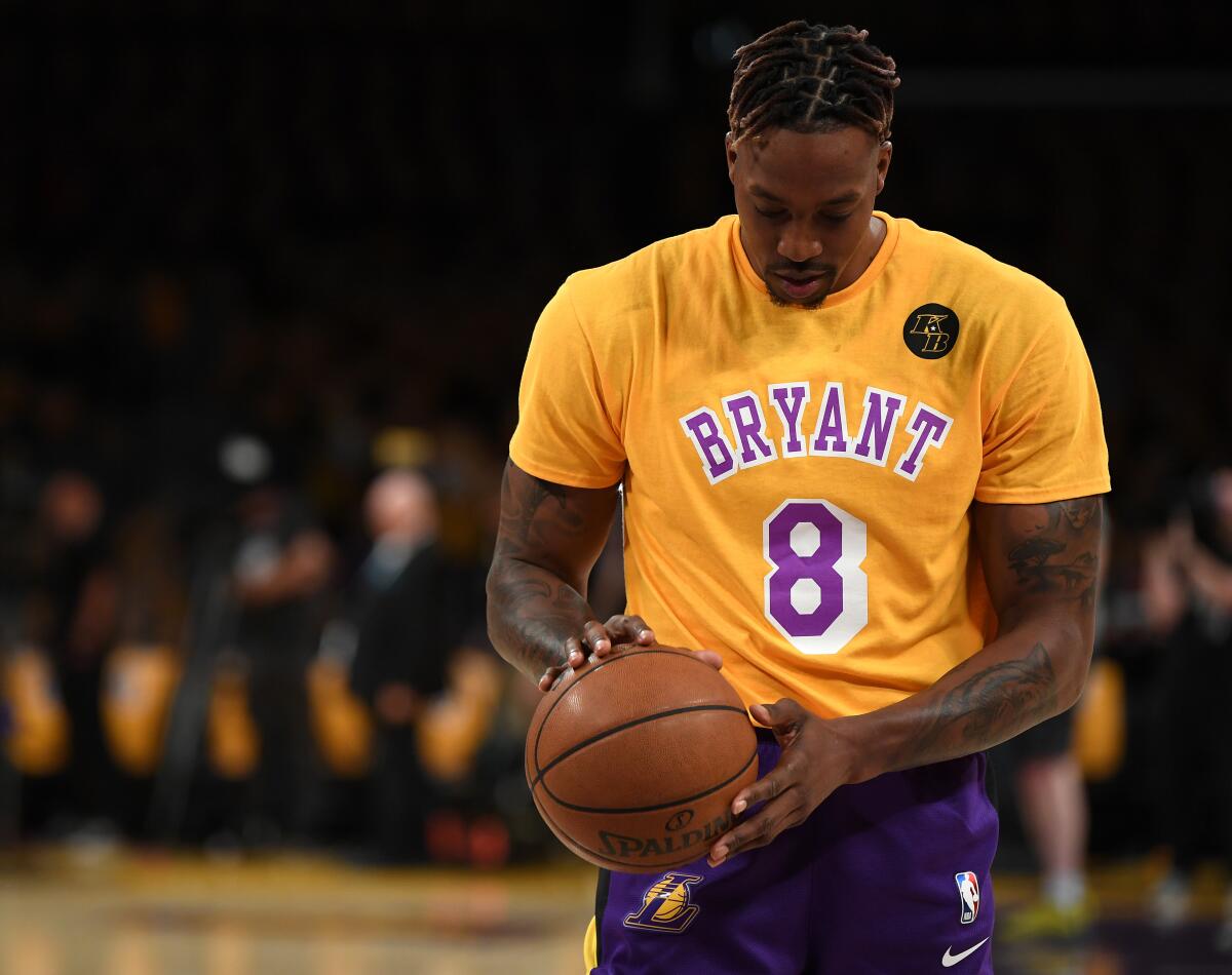 Dwight Howard wears a Kobe Bryant jersey over his warmups before a pregame ceremony Jan. 31 to honor the life of Kobe Bryant, who died in a helicopter crash with his daughter Gianna and seven others on Jan. 26r.