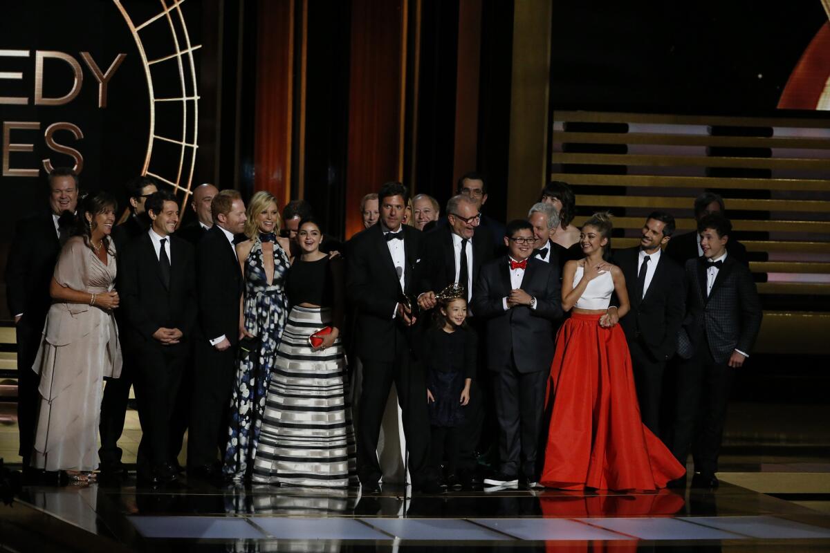 The cast of "Modern Family" accepts the Emmy for comedy series.