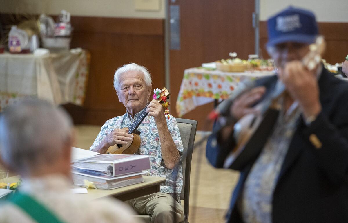 Tony Cappa, 97, plays his ukulele at the Oasis Senior Center in Corona del Mar on Monday. Cappa spent 37 years as the center's ukulele club president.