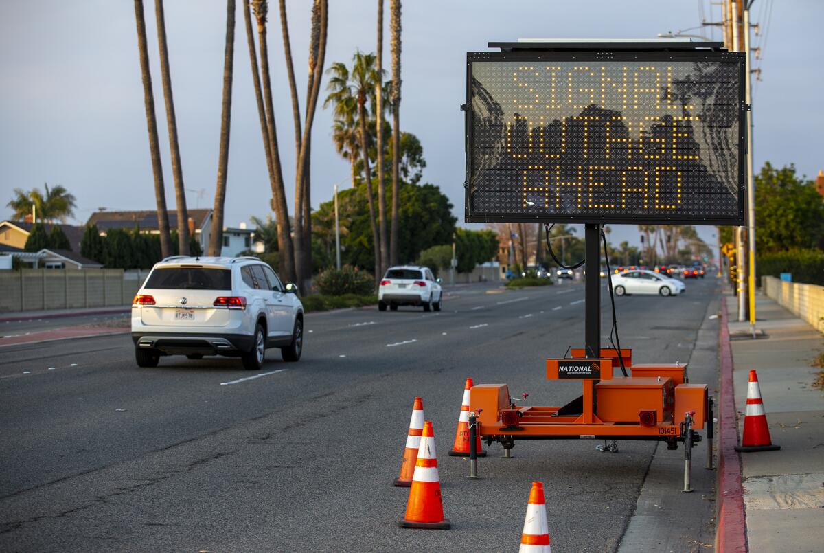 A portable sign warns drivers of a signal outage at the intersection of Atlanta Avenue and Brookhurst Street on Monday.