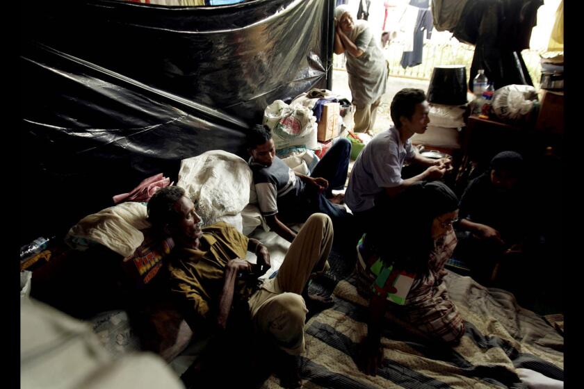 On Jan. 16, 2005, Sofyan Amzit and his family rest in a tent in the Samahani Refugee Camp.