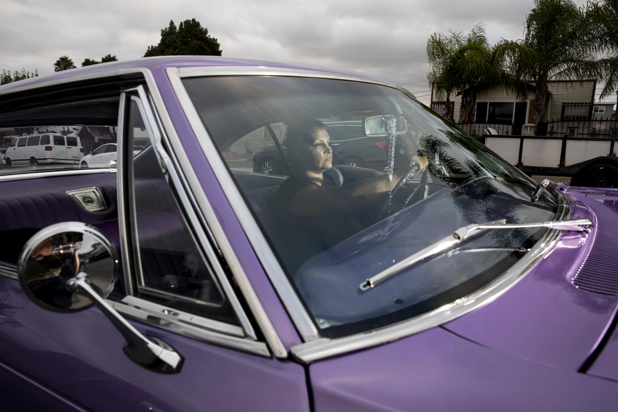 Sofia Toral, 40, poses in her 1965 Impala last month in National City. 