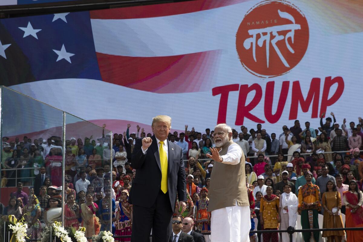 President Trump and Indian Prime Minister Narendra Modi wave after a "Namaste Trump" event in Ahmedabad, India, Feb. 24, 2020.
