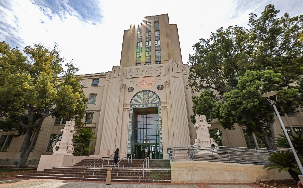 People walk into the entrance at the San Diego County Administration Building on Friday, July 30, 2021 in San Diego, CA.