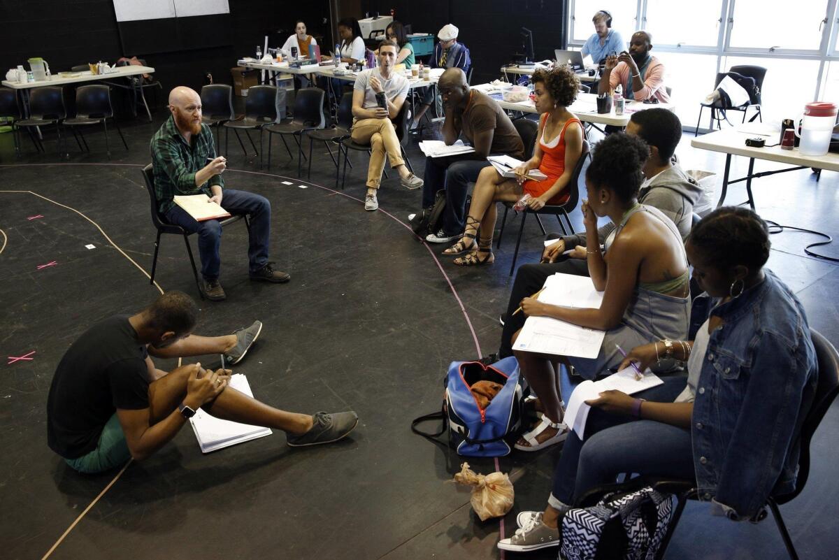 Brody, Augustin and cast review notes at a rehearsal for “Last Tiger in Haiti.” Previews begin Tuesday. — Nancee Lewis