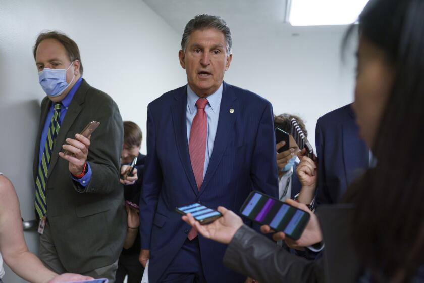 Sen. Joe Manchin, D-W.Va., is surrounded by reporters as senators rush to the chamber for votes ahead of the approaching Memorial Day recess, at the Capitol in Washington, Wednesday, May 26, 2021. Lawmakers still face standoffs on an infrastructure bill, police reform, voting rights, and a bipartisan commission to investigate the Jan. 6 attack on the Capitol. (AP Photo/J. Scott Applewhite)