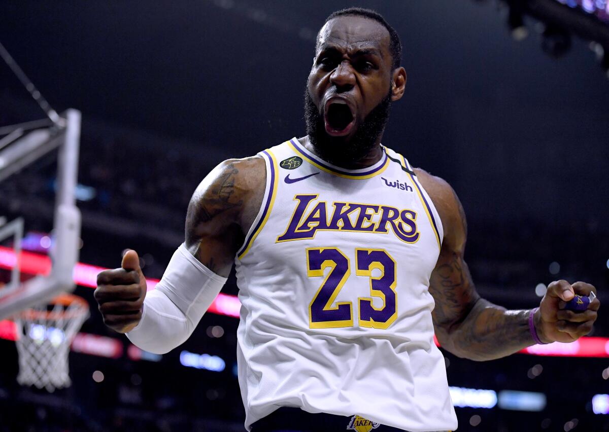 Lakers star LeBron James celebrates after scoring and drawing a foul during a 112-103 victory over the Clippers at Staples Center on Sunday.