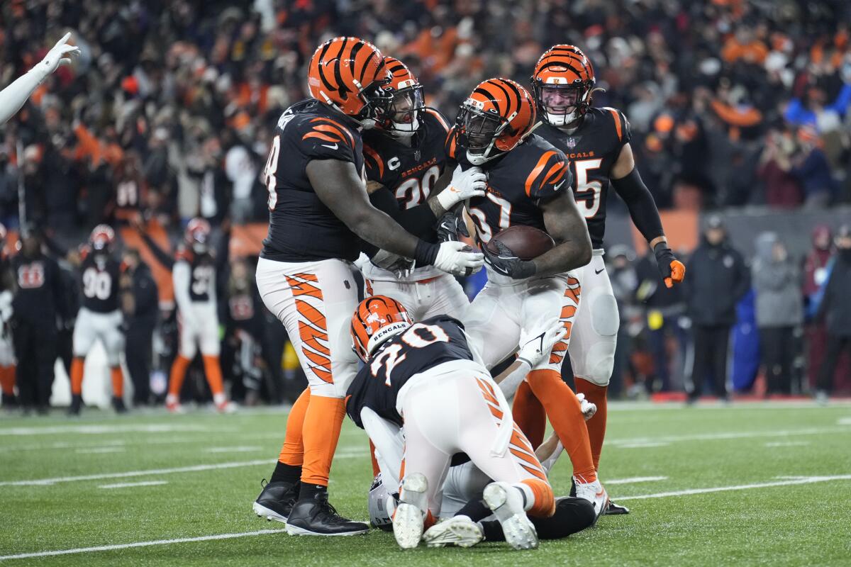 Cincinnati linebacker Germaine Pratt (57) is congratulated by teammates after intercepting a pass late in the game.