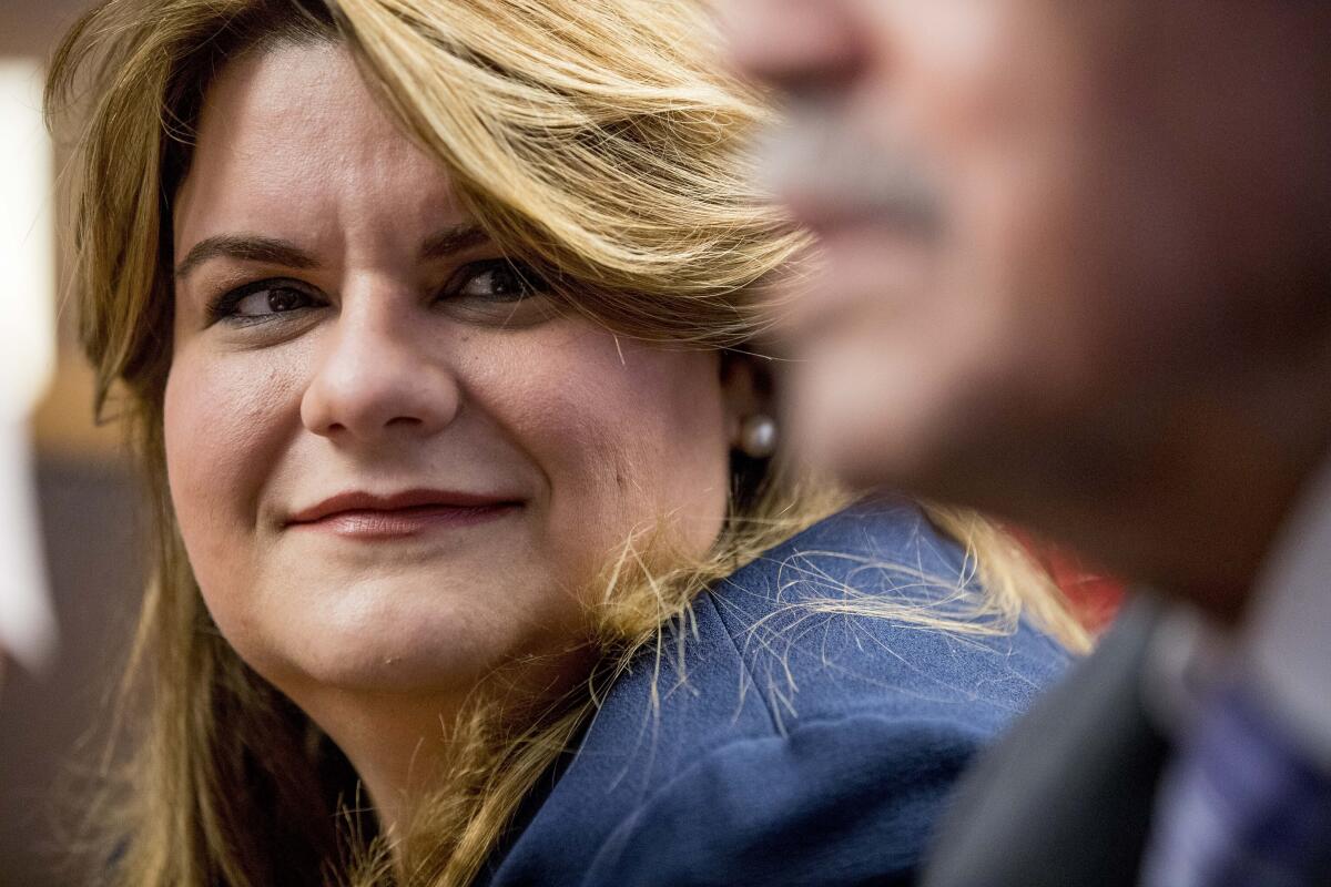 Jenniffer Gonzalez-Colon smiles at a news conference.