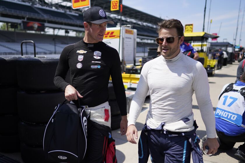 Ryan Hunter-Reay, left, talks with Marco Andretti, right, following practice for the Indianapolis 500 auto race at Indianapolis Motor Speedway, Monday, May 22, 2023, in Indianapolis. (AP Photo/Darron Cummings)