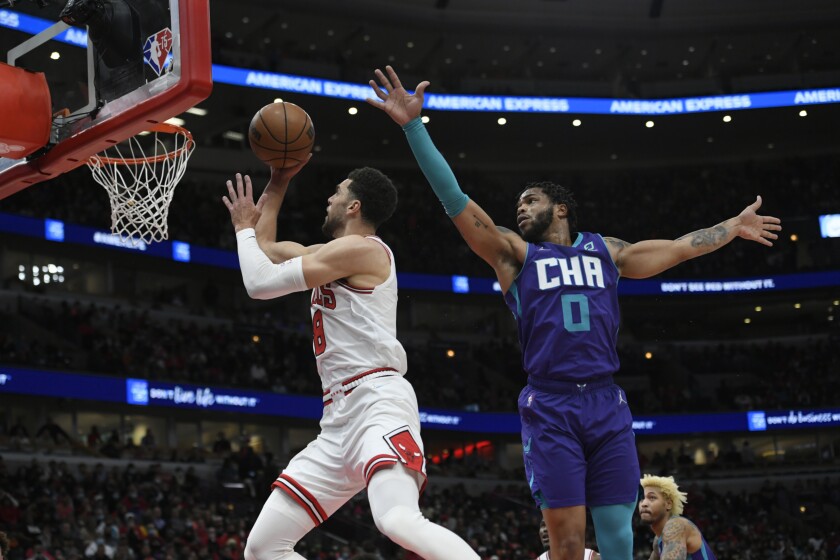 Chicago Bulls guard Zach LaVine (8) goes up for a shot against Charlotte Hornets forward Miles Bridges (0) during the first half of a NBA basketball game Monday, Nov. 29, 2021 in Chicago. (AP Photo/Paul Beaty)