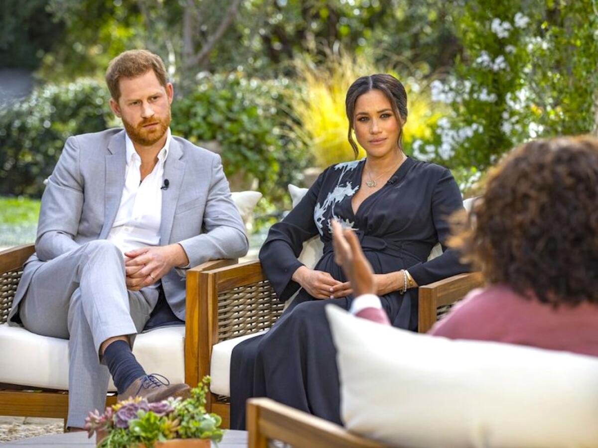 Harry and Meghan listen to a question from Oprah Winfrey.