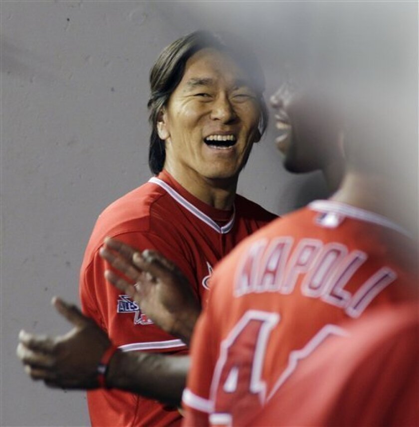 Los Angeles Angels' Hideki Matsui smiles in the dugout after he hit a two-run home run in the seventh inning of a baseball game against the Seattle Mariners, Wednesday, Sept. 1, 2010, in Seattle. (AP Photo/Ted S. Warren)