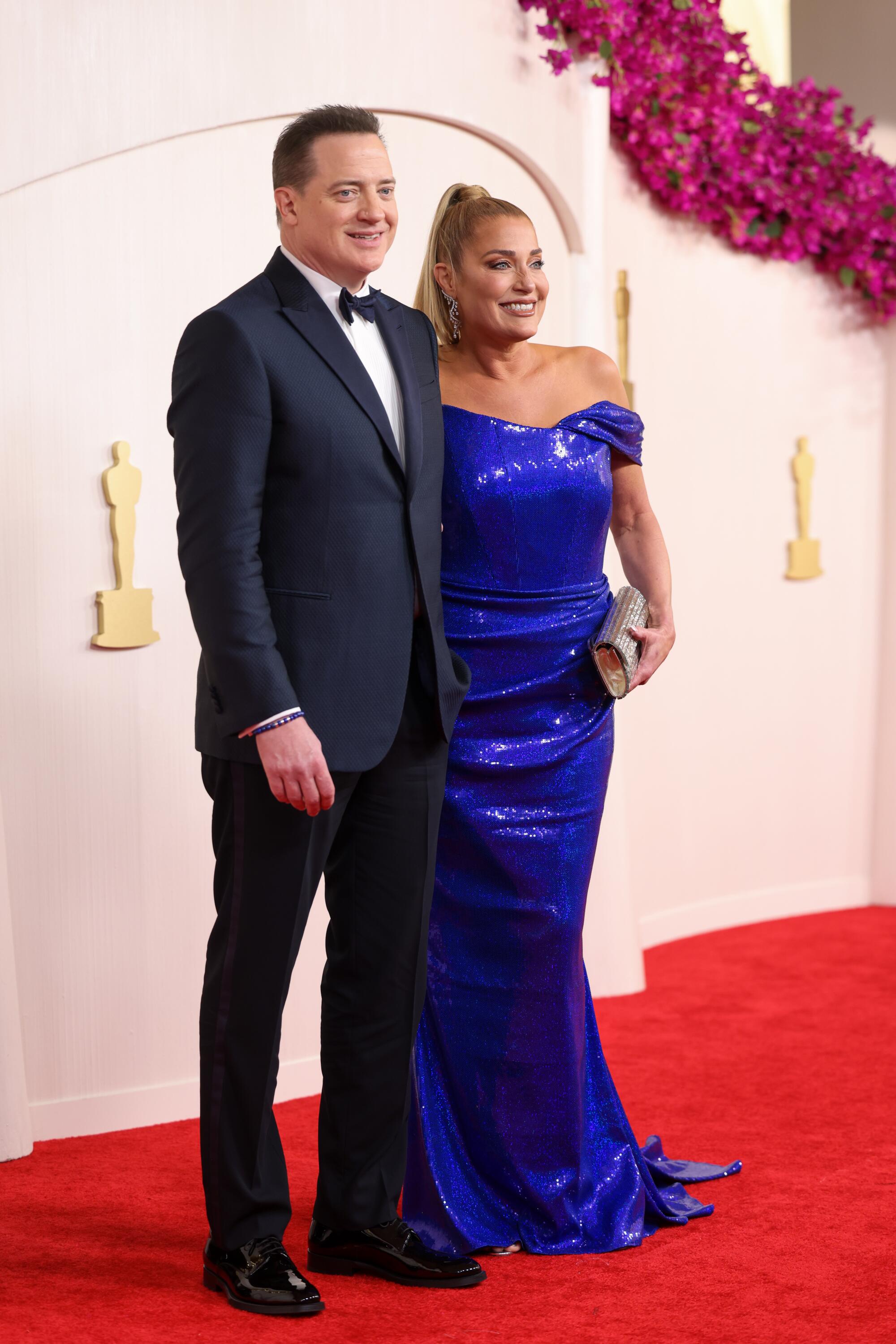 Brendan Fraser and Jeanne Moore, both in blue, smile for the cameras. 