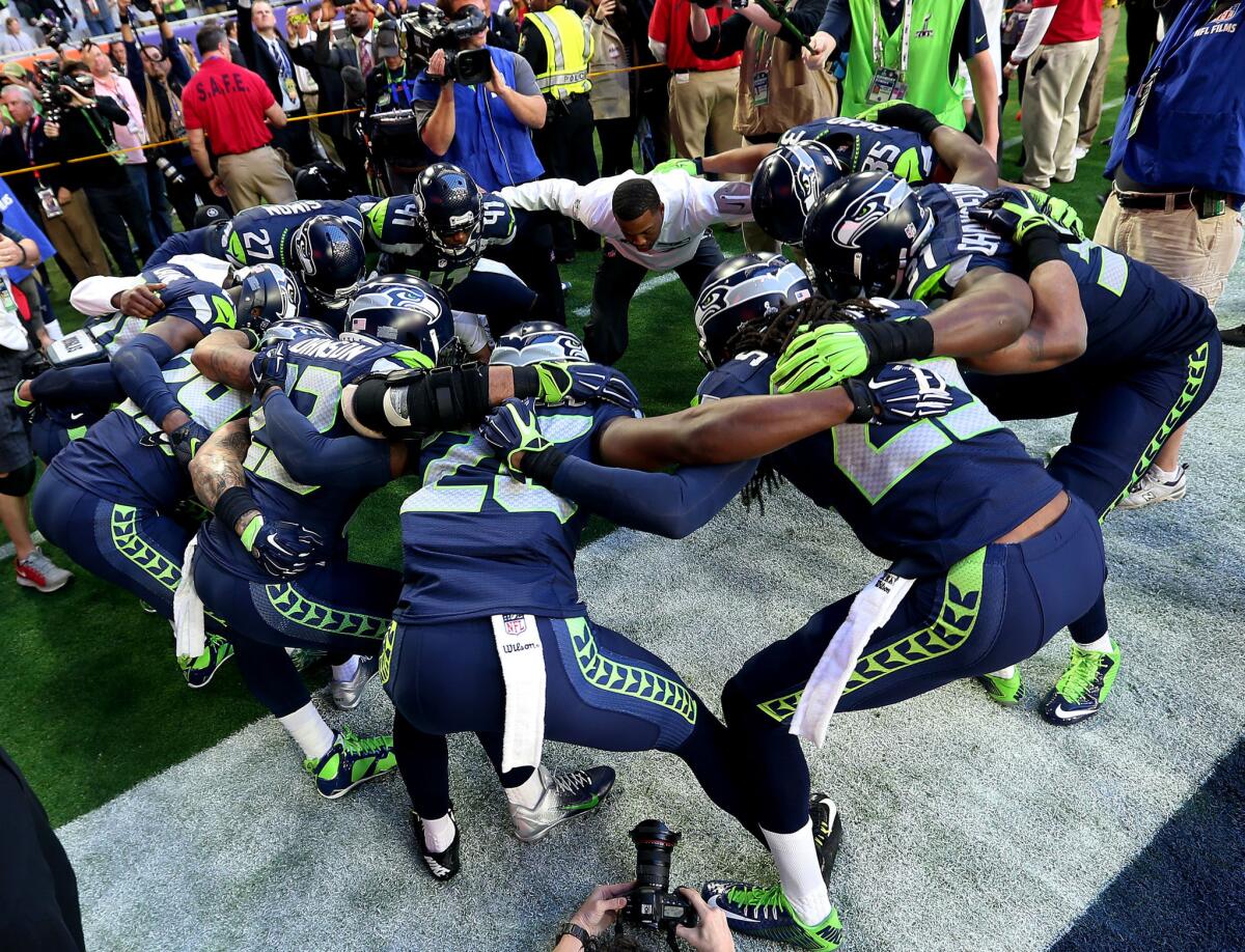 Members of the Seattle Seahawks defense huddle up before the start up Super Bowl XLIX against the New England Patriots on Feb. 1 at University of Phoenix Stadium in Glendale, Ariz.