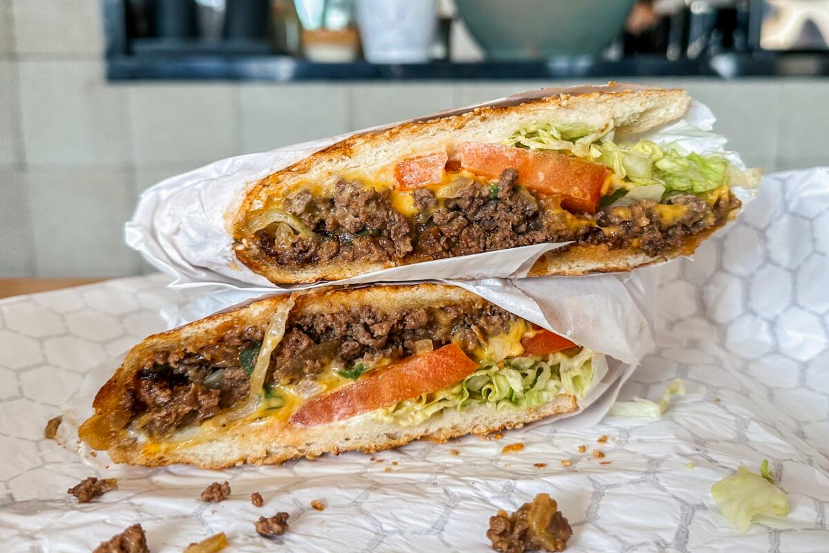 Chopped cheese sandwich in two paper-wrapped halves at Bodega Park in Silver Lake.