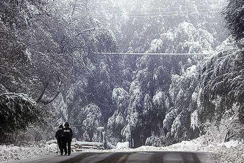 Elizabeth and So Lee hike down Mt. Baldy in the San Gabriel Mountains amid snow brought by the first of three storms expected to affect Southern California into the weekend.