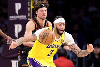 Los Angeles, California February 29, 2024-Lakers Anthony Davis picks up a loose ball against the Wizards.