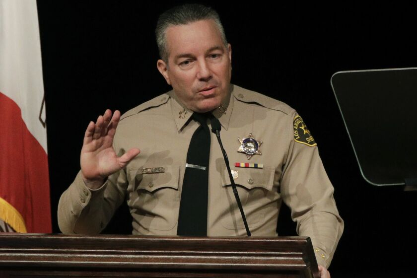 FILE - In this Dec. 3, 2018 file photo newly-elected Los Angeles County Sheriff Alex Villanueva speaks during a swearing-in ceremony in Monterey Park, Calif. Villanueva will limit when inmates in the county's jails can be transferred to federal authorities for deportation. Sheriff's Department spokeswoman Nicole Nishida said on Friday, Feb. 15, 2019, the agency will reduce the number of misdemeanor charges that can trigger an inmate's transfer. She could not immediately say which misdemeanor charges would no longer qualify. (AP Photo/Jae C. Hong, File)