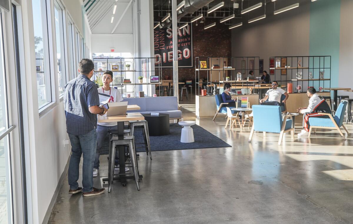 Lyft drivers and support personnel work in the lounge area at the Lyft Driver Center last week in San Diego.