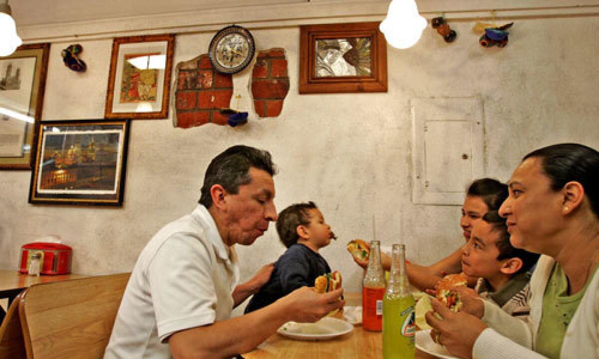 DIGGING IN: The Flores family from Lancaster enjoys their cemitas at Cemitas Poblanos Don Adrian restaurant in Van Nuys.
