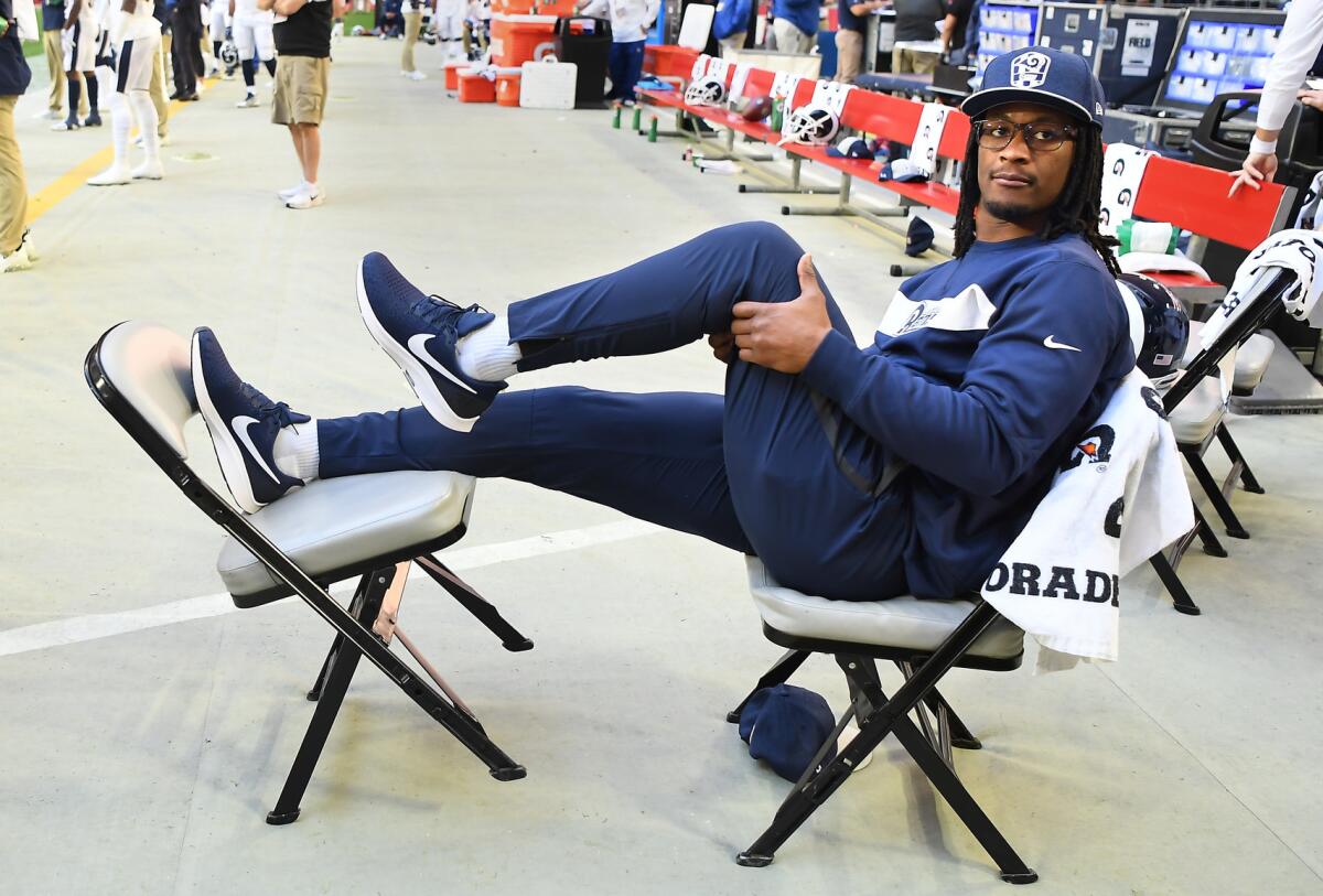Los Angeles Rams running back Todd Gurley spits water as he sits