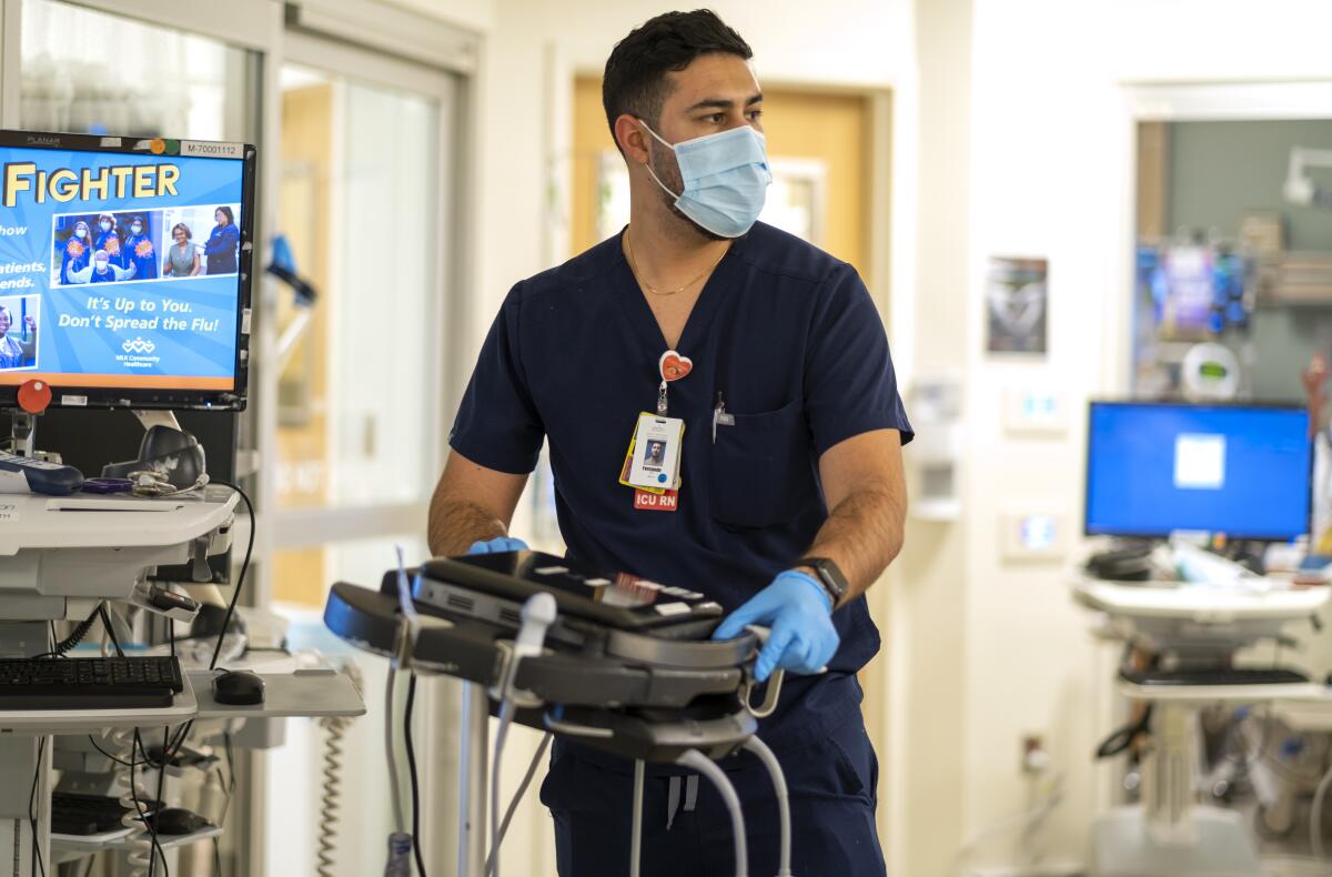 A nurse in scrubs in a hospital