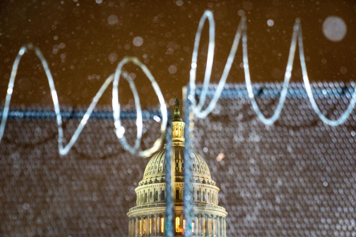 Razor wire is part of the fencing near the Capitol as the Senate begins former President Trump's second impeachment trial.