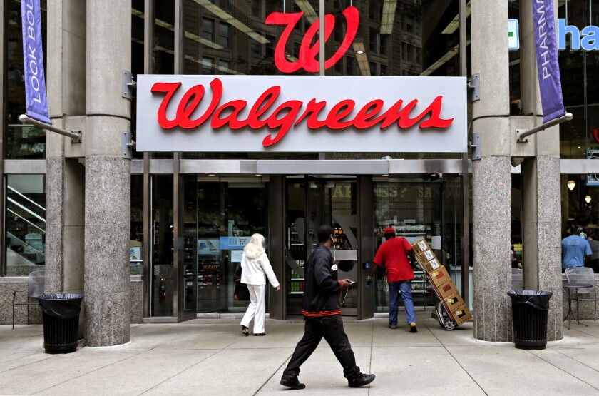 People walk in to a Walgreens retail store.