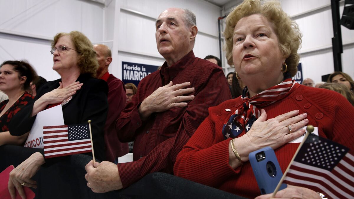 Michael Purcell, center, and Sandra Purcell, right, of Longwood, Fla., attend a Marco Rubio event in Sanford, Fla., on March 8, 2016.