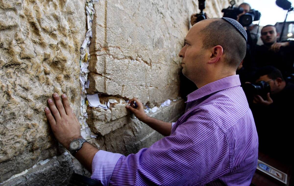 Naftali Bennett, head of the Jewish Home party, touches the Western Wall in Jerusalem's Old City in January.