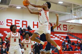 Tajh Ariza of Westchester goes airborne against Brentwood.