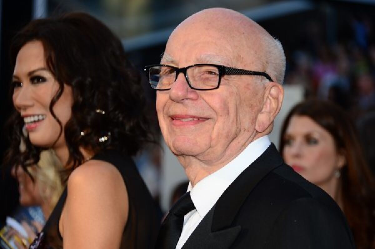 Rupert Murdoch and wife Wendi Deng Murdoch arrive on the red carpet for the 85th Academy Awards in Hollywood.