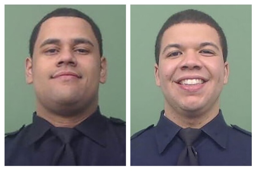 This photo combo of images provided by the New York City Police Department shows NYPD Officers Wilbert Mora, left, and Jason Rivera. The two officers were shot while answering a call about an argument between a woman and her adult son in the Harlem neighborhood of New York, Friday, Jan. 21, 2022. (Courtesy of NYPD via AP)