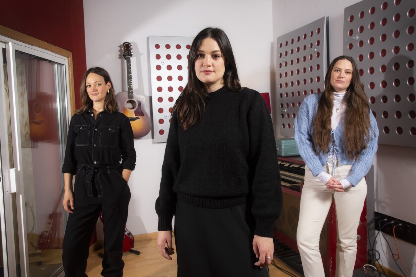 Folk group, The Staves, from left, sisters, Emily, Jessica and Camilla Staveley-Taylor pose in a north London recording studio to promote their album "Good Woman", on Monday, Feb. 15, 2021. (Photo by Joel C Ryan/Invision/AP)