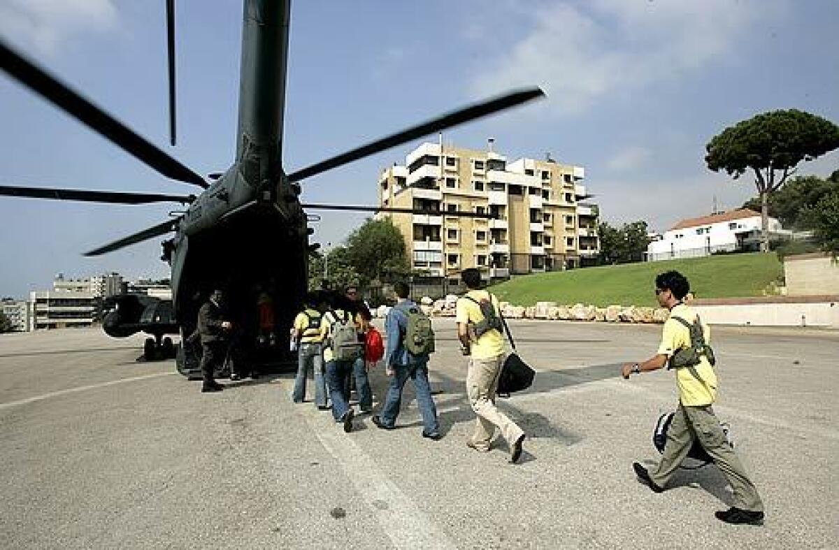 Lebanese high school exchange students board a U.S. Air Force helicopter parked on the grounds of the American Embassy in Beirut. Sponsored by the Youth Exchange and Study (YES) scholarship program, 27 students destined for the United States were airlifted after weeks of uncertainty due to the war.