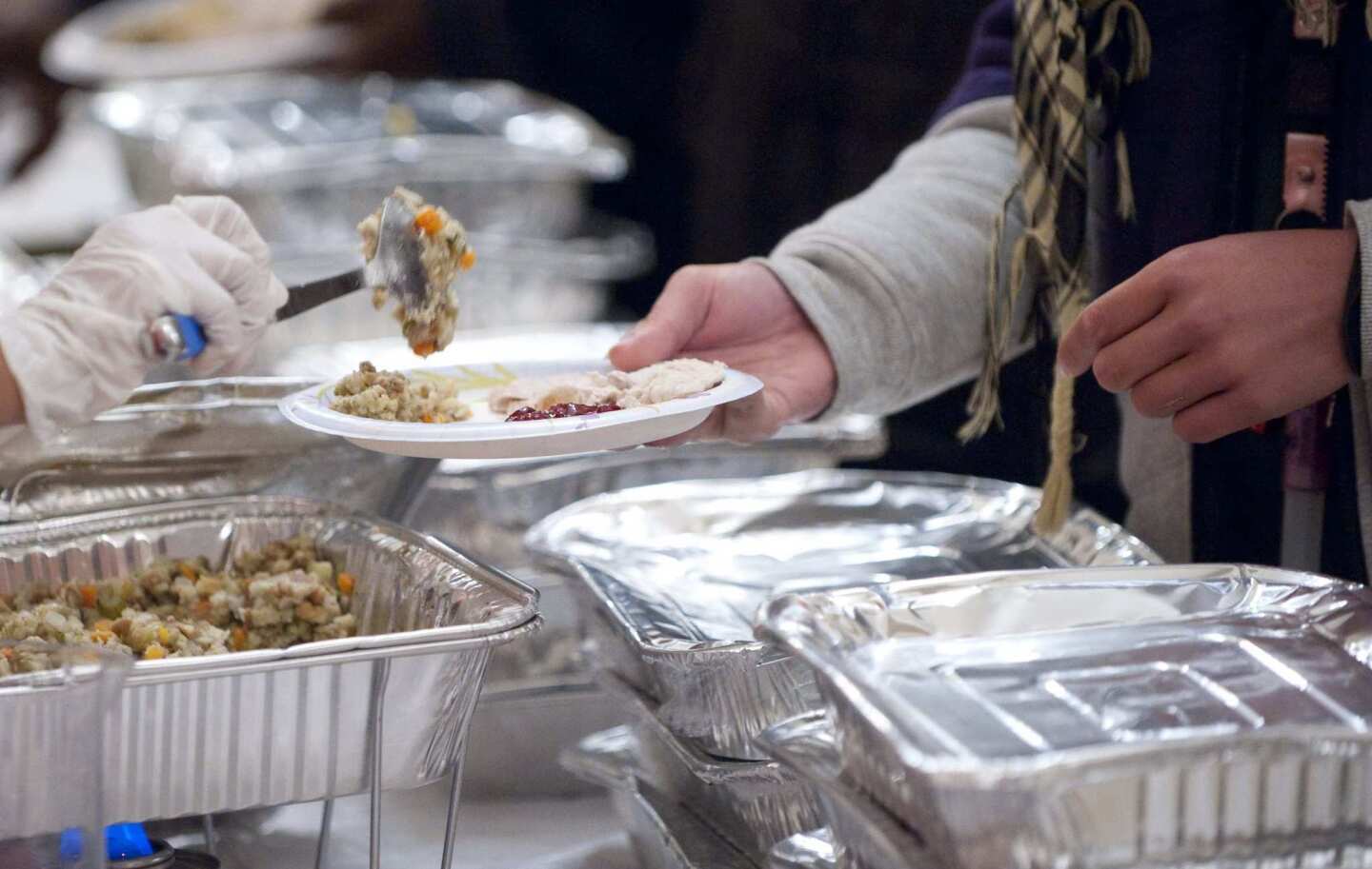 Occupy D.C. demonstrators receive a Thanksgiving meal from volunteers at the New York Avenue Presbyterian Church in Washington.