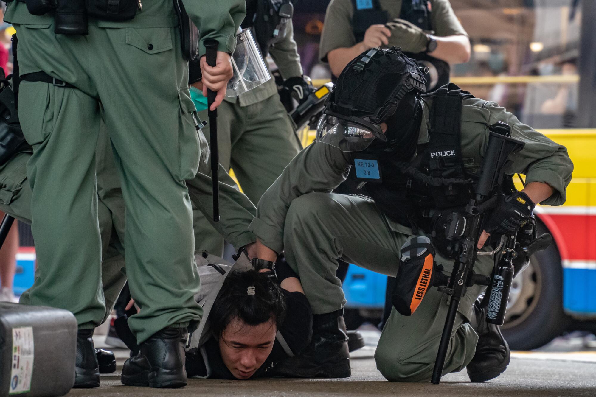 Riot police arrest a man Wednesday during a demonstration against the new national security law in Hong Kong. 
