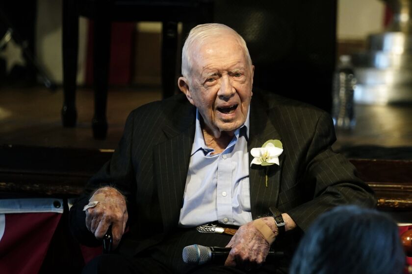 FILE - Former President Jimmy Carter reacts as his wife Rosalynn Carter speaks during a reception to celebrate their 75th wedding anniversary Saturday, July 10, 2021, in Plains, Ga.. (AP Photo/John Bazemore, Pool, File)